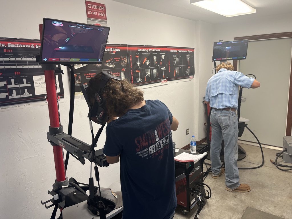 two students on virtual welders in classroom 