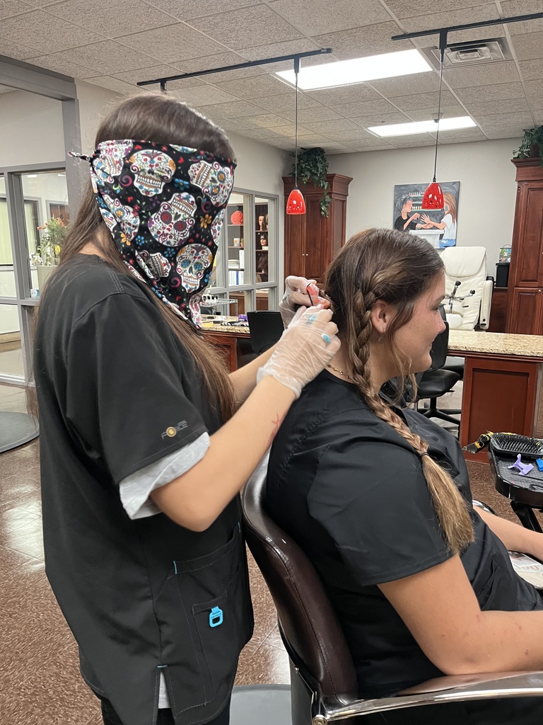 Blindfolded student attempts hairstyle in the salon 